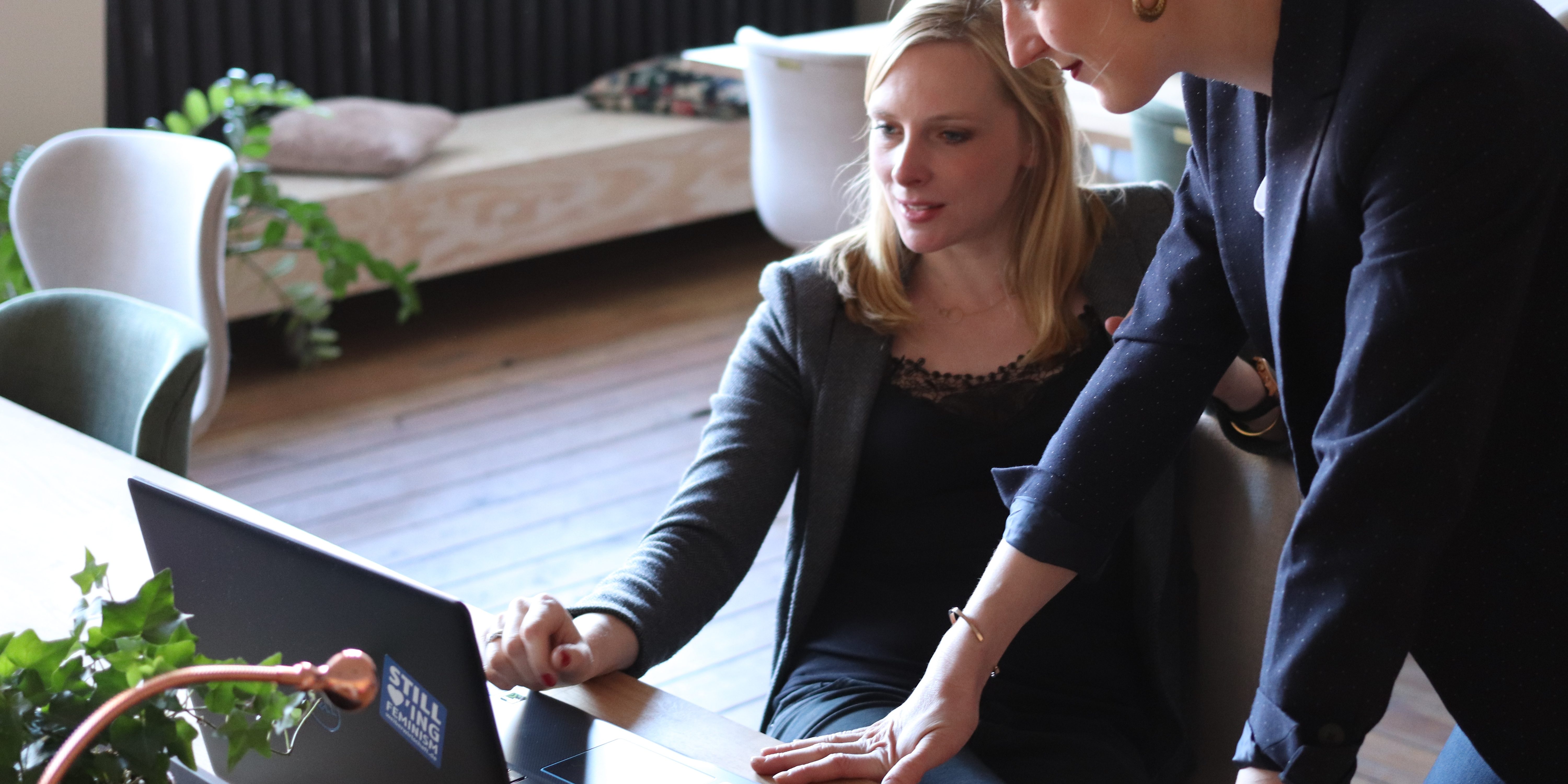 How to Plan a Corporate Event in 9 Easy Steps two women at a laptop working on scheduling their next event